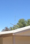 Dipole end tied off to a straining TV antenna pole